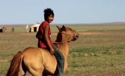 A boy riding horse